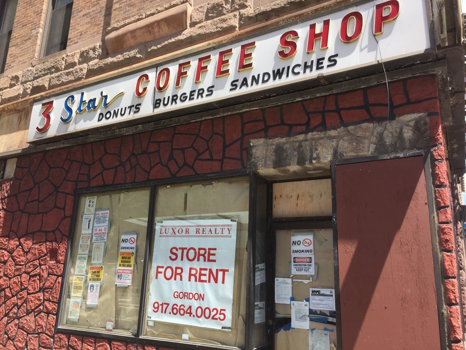 Storefront with “3 Star Coffee Shop” sign above a store window displaying a sign stating “STORE FOR RENT” with a broker’s phone number.