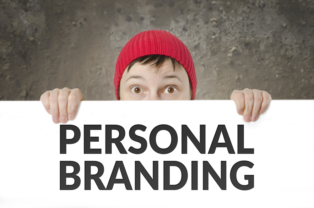Person holding sign that says "Personal Branding"