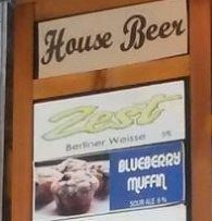 Specimen sign with a “House Beer” heading and a BLUEBERRY MUFFIN listing below