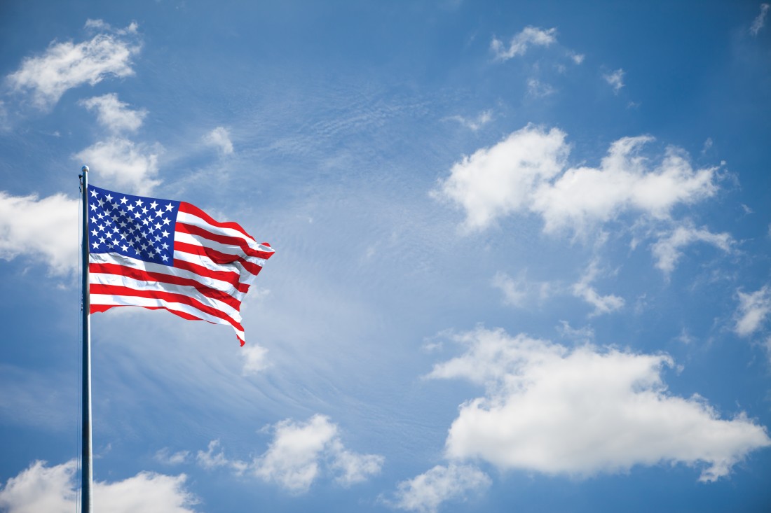 Photograph of American Flag on blue sky