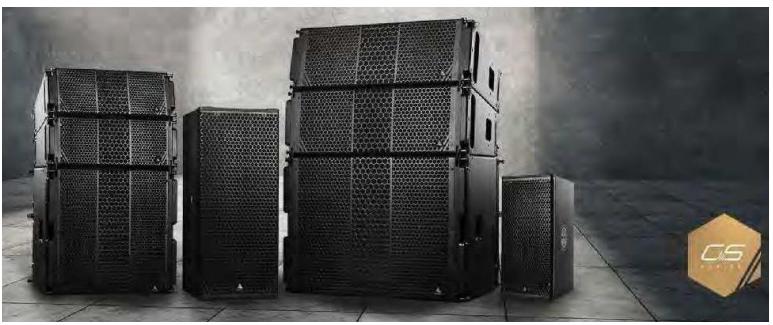 Black and white picture of four large audio speakers beside a tan-colored hexagon 