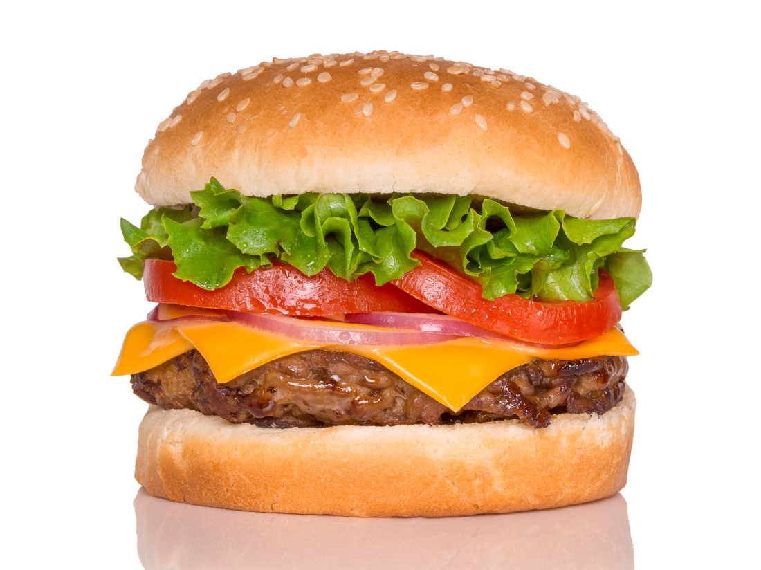 (Bottom to top) Bun, burger patty, cheese, onion rings, tomato slices, lettuce, sesame seed bun