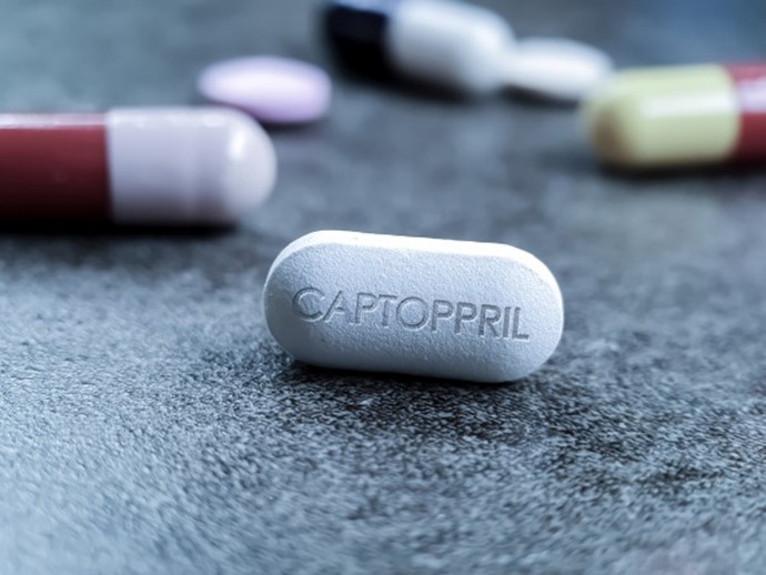 Photo of capsules, one of which displays “CAPTOPRIL.” 