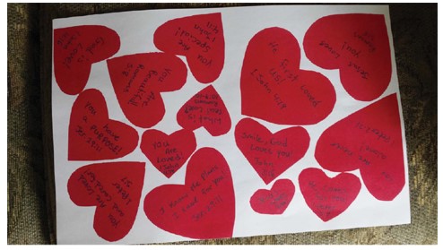 Court exhibit of various sizes of red heart-shaped cards displaying messages