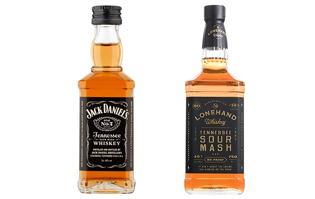 Jack Daniels Whiskey bottle next to Lonehand Whiskey Bottle