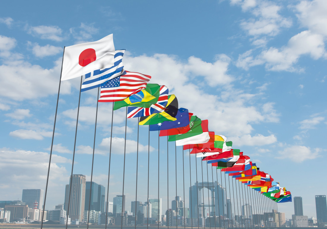 A series of national flags waving on flagpoles