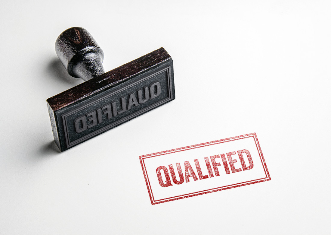 Rubber Stamp saying “Qualified”