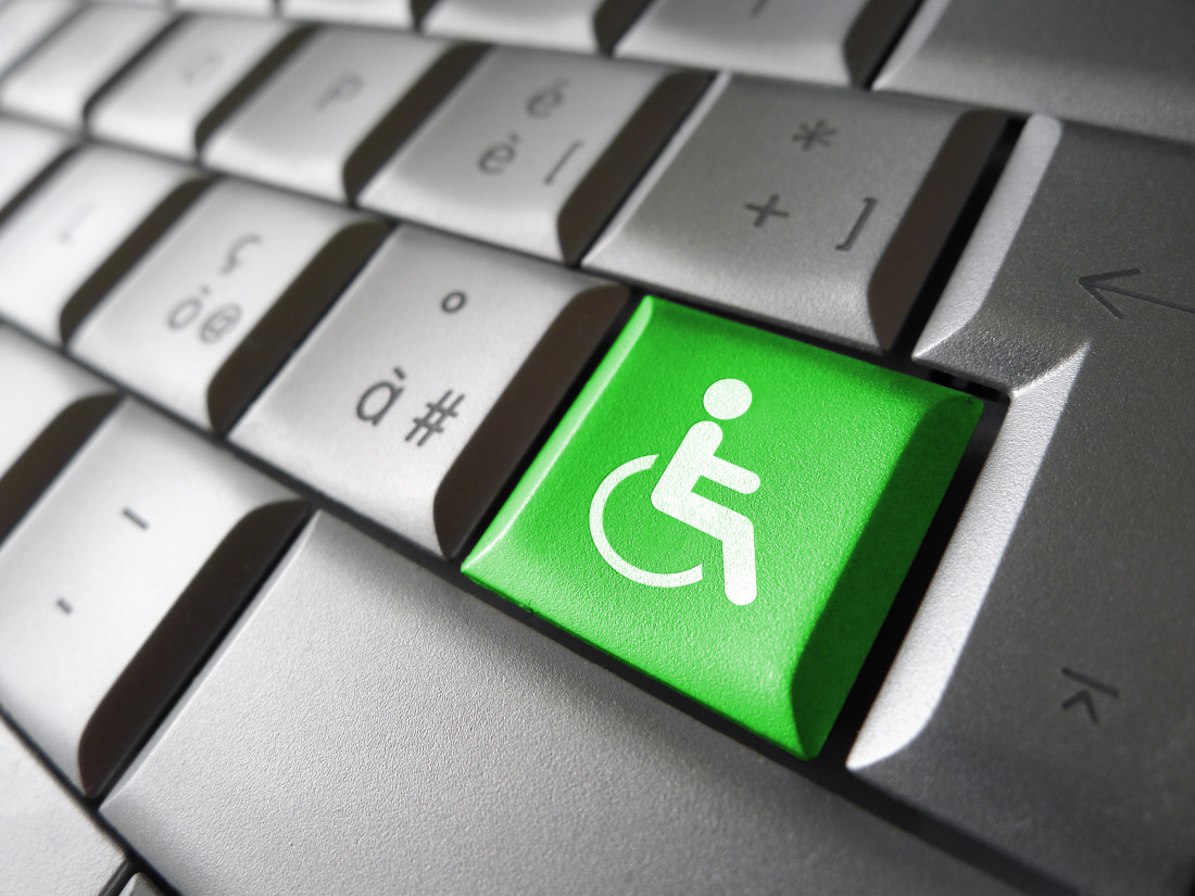 Wheelchair icon and symbol on a green computer key