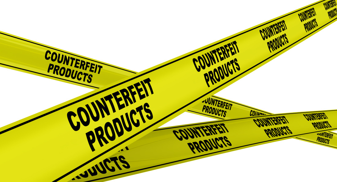 Yellow warning tapes with repeating black text COUNTERFEIT PRODUCTS