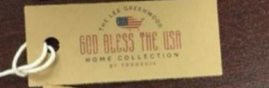 Hang Tag displaying THE LEE GREENWOOD in an arc above an American Flag in the shape of the United States above GOD BLESS THE USA in large letters above HOME COLLECTION in smaller letters 