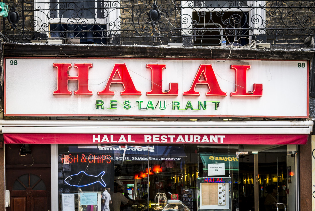 Restaurant sign awning both displaying HALAL RESTAURANT