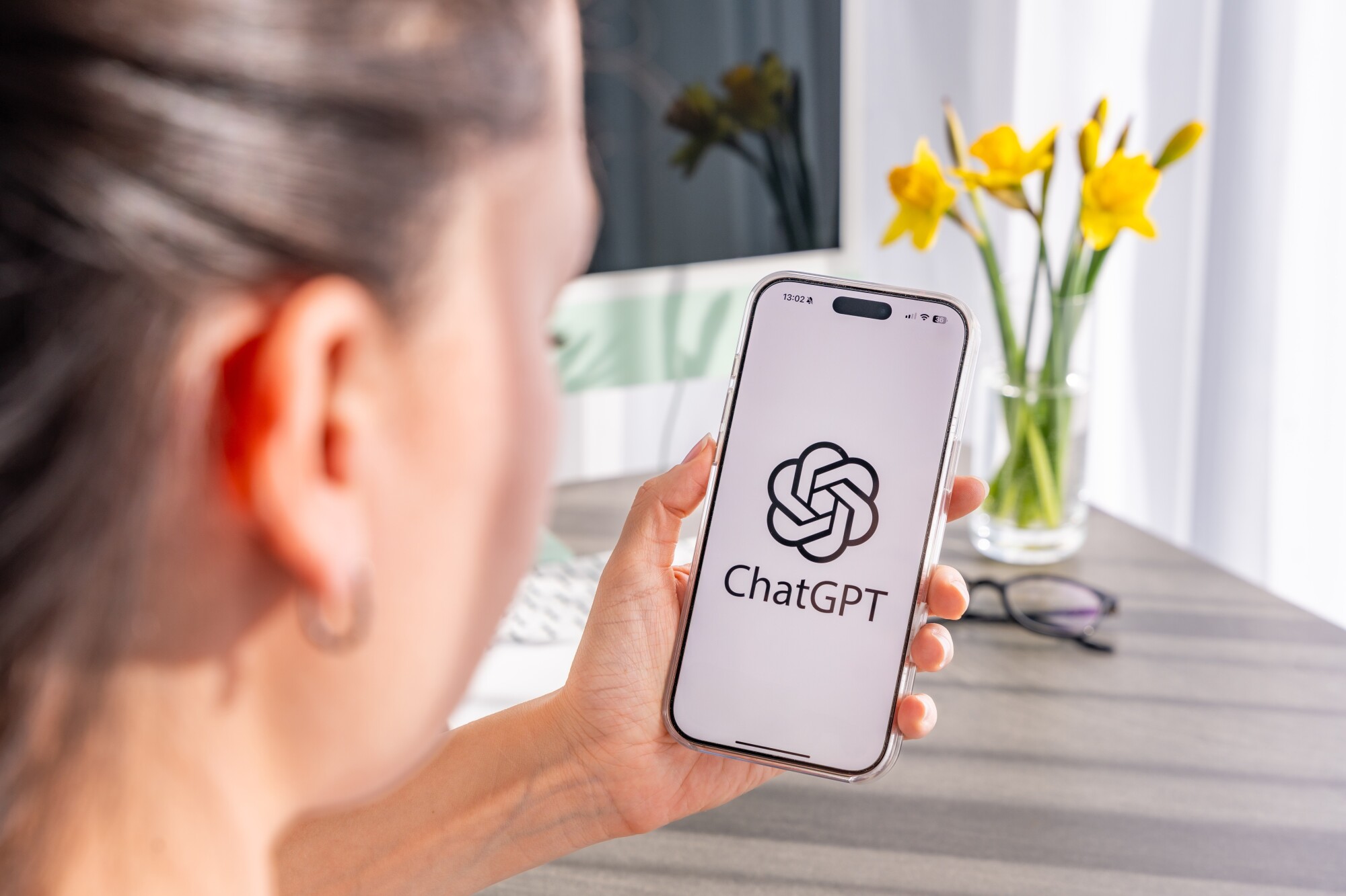 woman holding iphone with chatgpt
